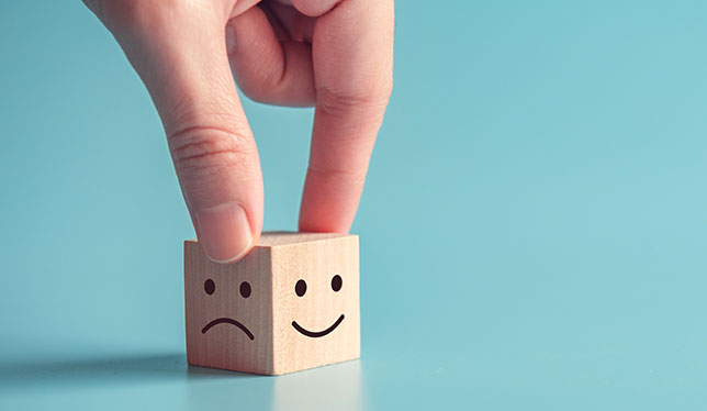 smiley face icon on wood cube