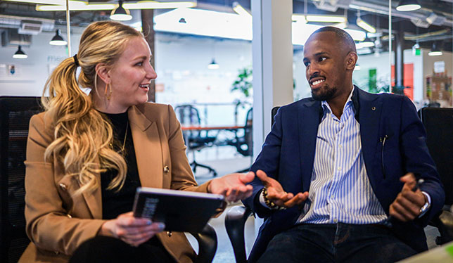 Two people talking in a business setting.