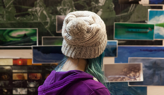 A student looks at an art exhibit at the