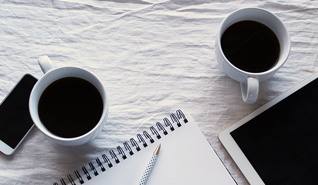 black coffee on cups with smartphone and tablet
